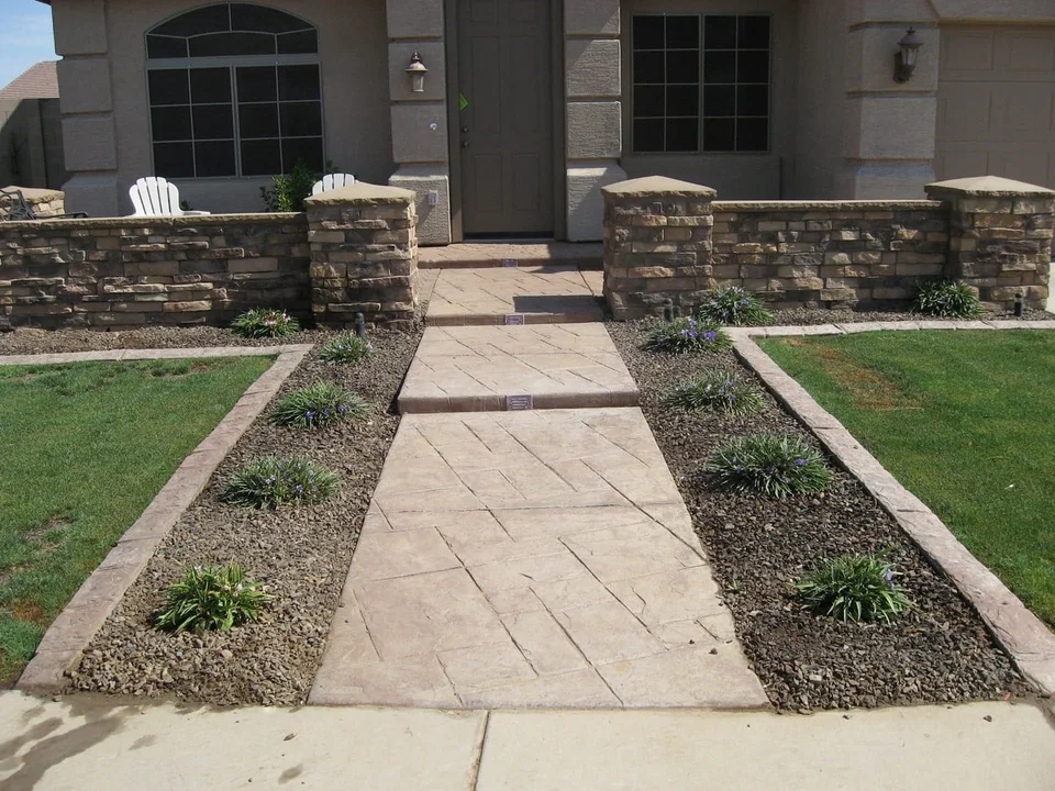 A direct front path is framed by lawn and planting beds.