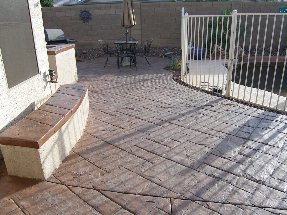 A sheltered outdoor area meets a low wall and gated opening.